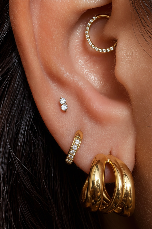 Gold hypoallergenic surgical steel labret piercing (Elmaiye Elara), suitable for tragus, helix, lobe, and conch piercings, shown as a minimalist stud-style body jewelry piece for ear cartilage and lobe use in the UK.