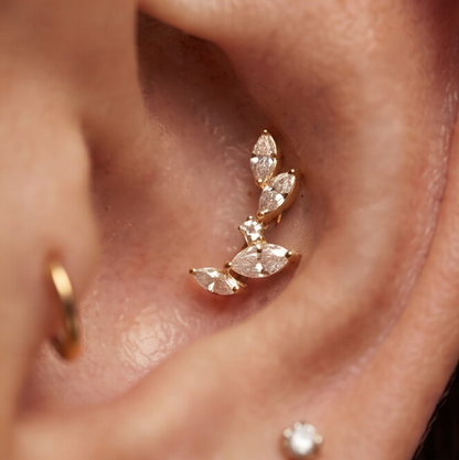 Close-up of a Flora Labret conch piercing on a model from Elmaiye — tarnish-free waterproof hypoallergenic PVD-coated gold piercing jewellery.